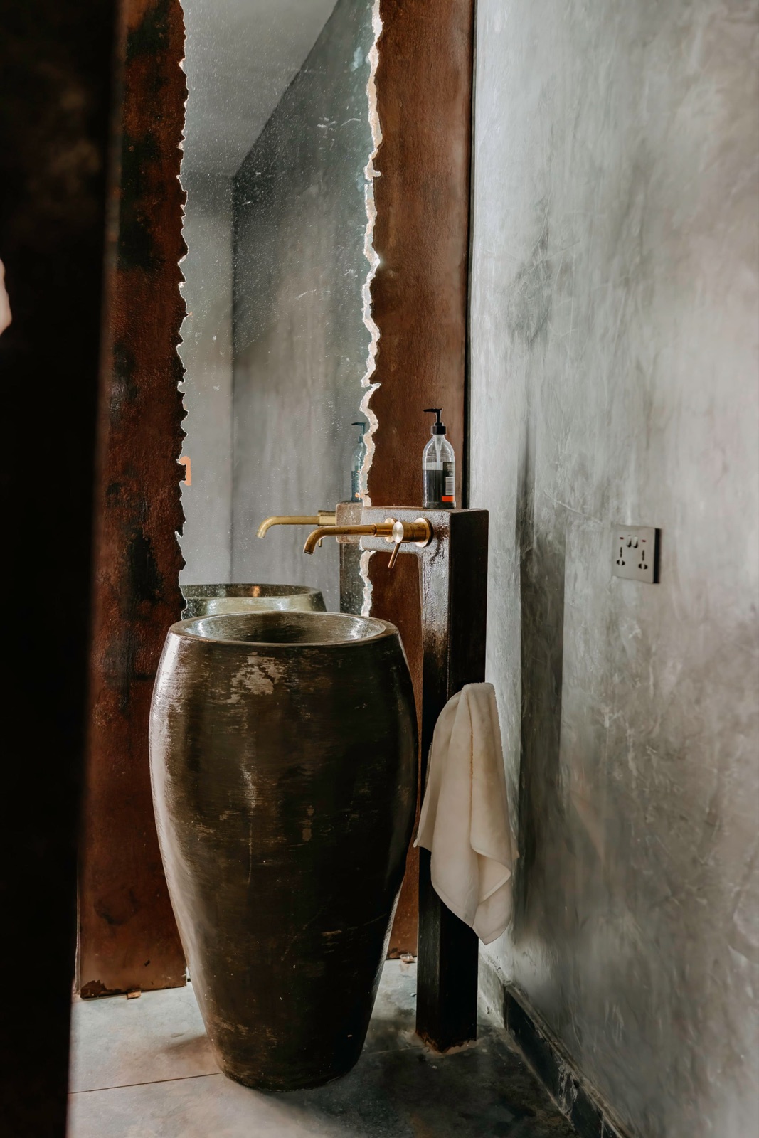 An artisan bronze vessel basin in an ensuite bathroom at WAZO Villa